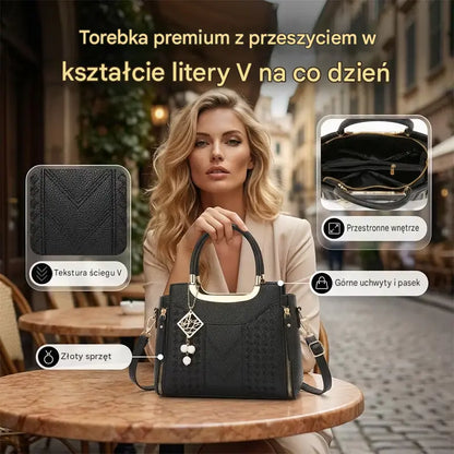 Damska torba na ramię z przeszyciami w kształcie litery V, złotymi okuciami, wieloma przegródkami i uchwytem u góry.